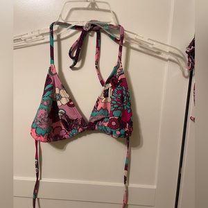 Floral Roxy bathing suit top. Size medium. Runs small. Pads have been removed.
